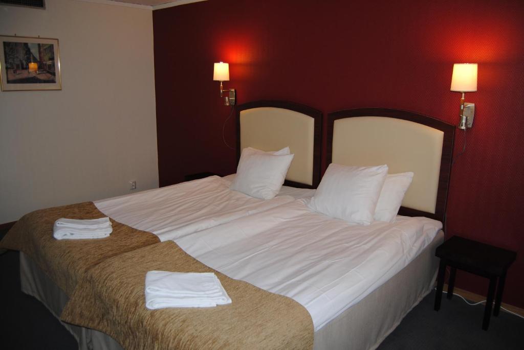 Postel nebo postele na pokoji v ubytování Arena Hotell