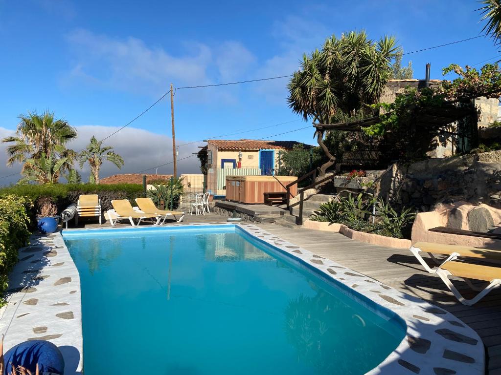 a swimming pool in front of a house at Casa Verde in Guía de Isora