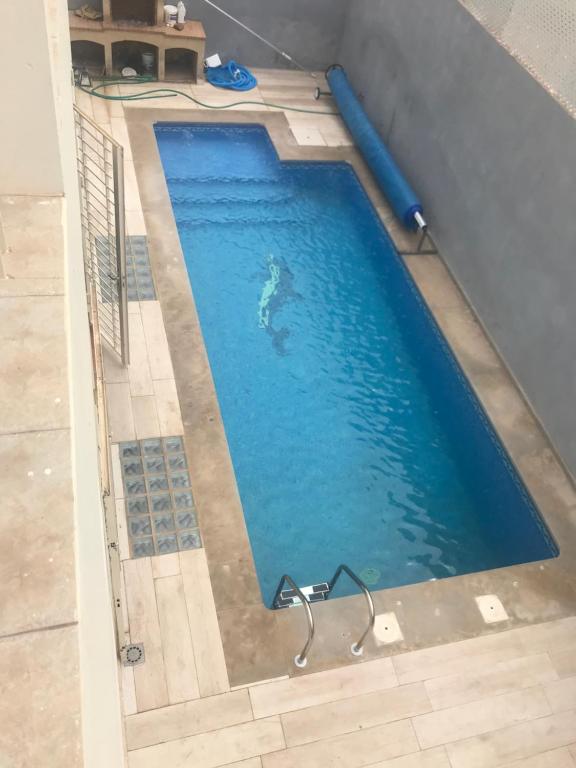 a swimming pool with blue water in a house at Luxury Villa at Ain-Diab in Casablanca