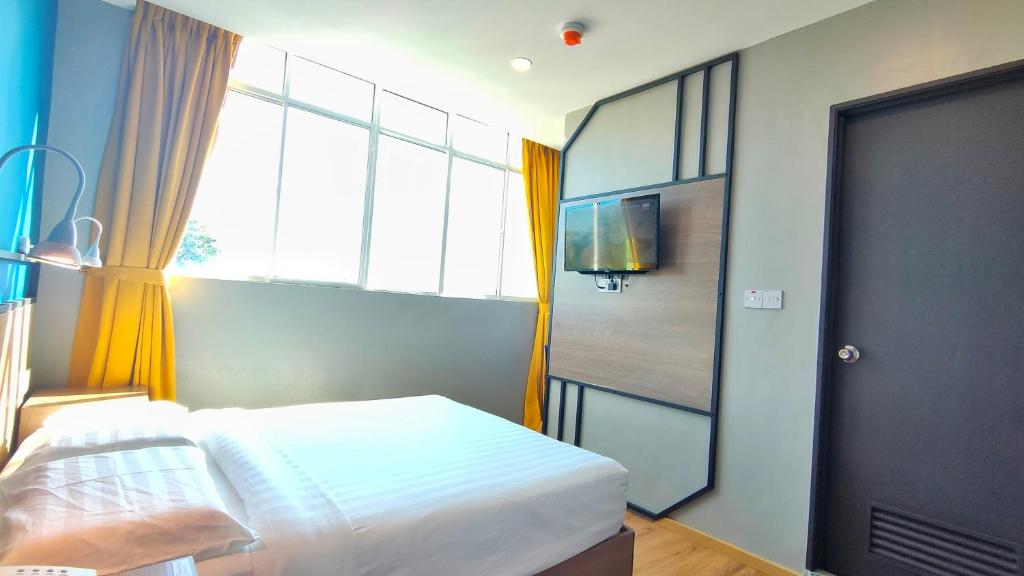 Postel nebo postele na pokoji v ubytování Uptown Hotel