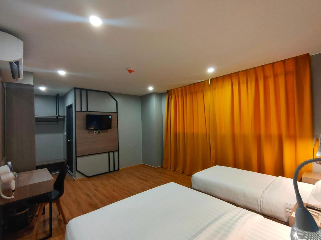 Postel nebo postele na pokoji v ubytování Uptown Hotel