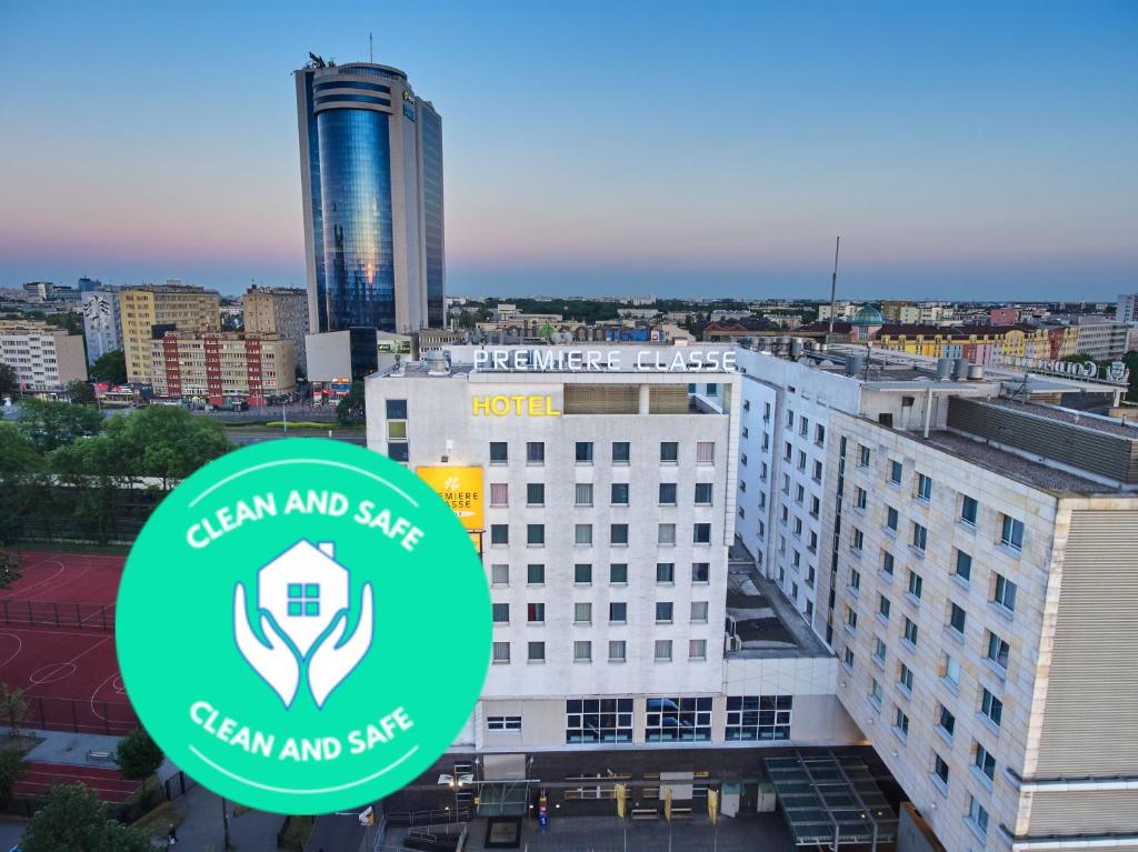 a view of a building with a green and safe sign on it at Premiere Classe Varsovie/Warszawa in Warsaw