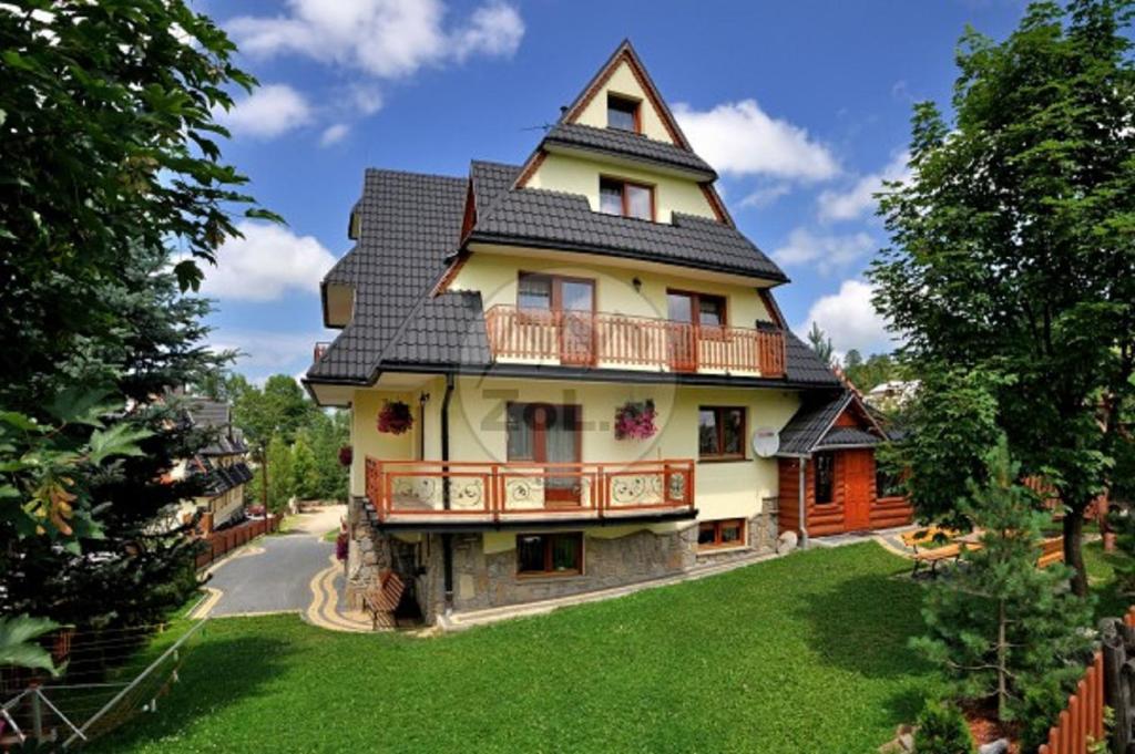 a large house with a gambrel roof at Willa Dziubas z jacuzzi & sauną in Male Ciche