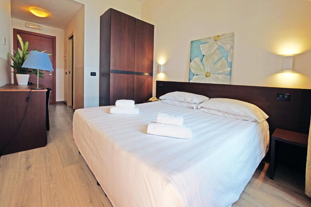 Postel nebo postele na pokoji v ubytování Hotel Corallo