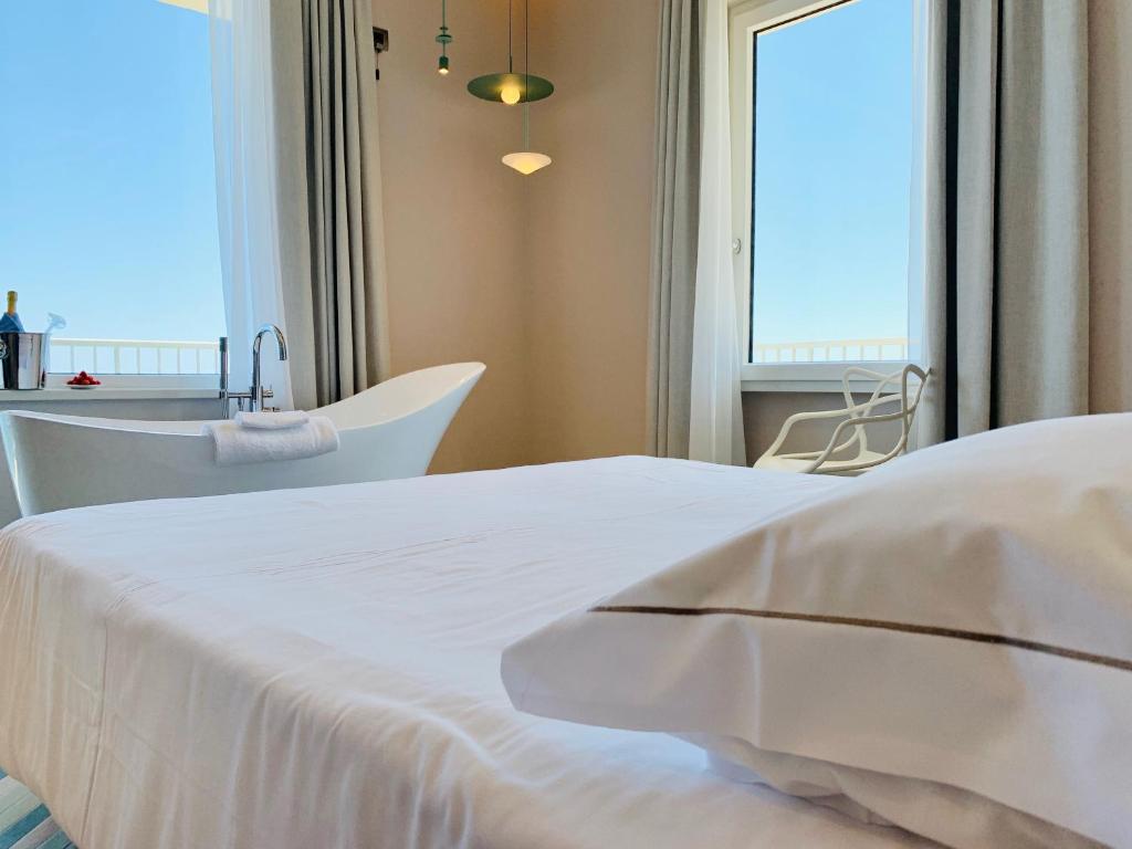Postel nebo postele na pokoji v ubytování Hotel Corallo