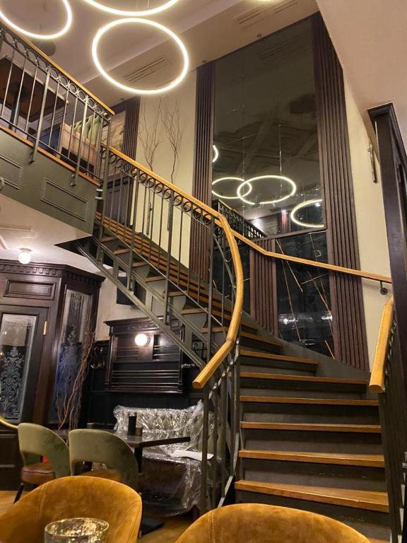 a spiral staircase in a building with chairs and tables at Hotel Eulenspiegel in Bretten