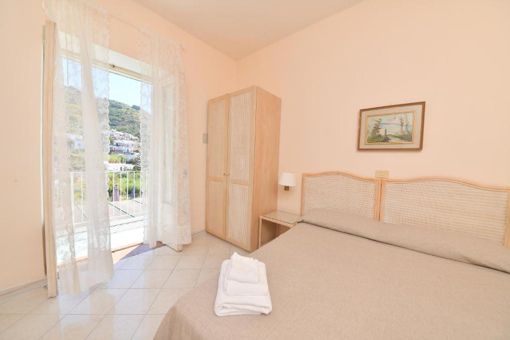 Postel nebo postele na pokoji v ubytování Hotel Maremonti