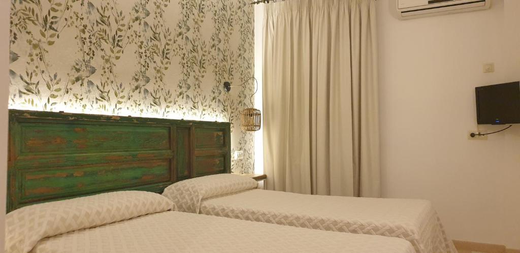 Postel nebo postele na pokoji v ubytování Hostal Macami
