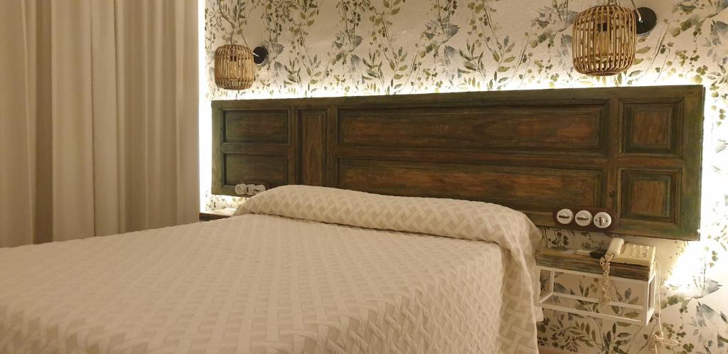 Postel nebo postele na pokoji v ubytování Hostal Macami