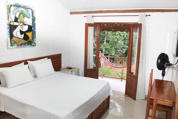 Uma cama ou camas num quarto em Pousada Vale Du'Carmo