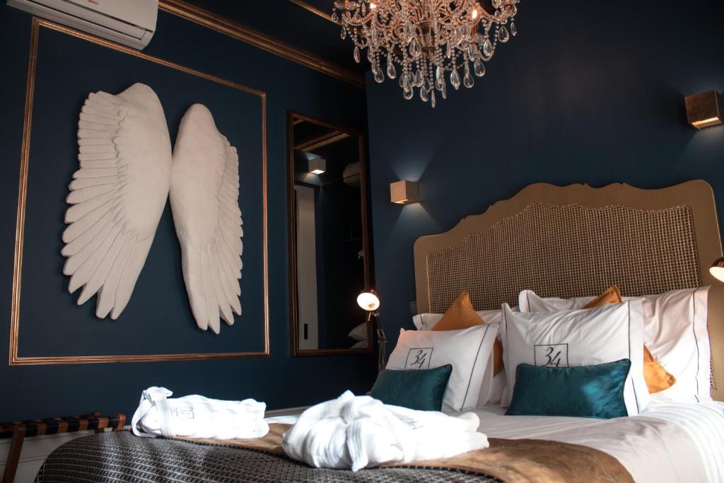 a bedroom with a bed with angel wings on the wall at 34 GuestHouse in Setúbal