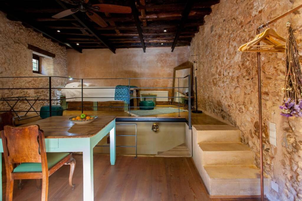 a kitchen with a table and stairs in a room at History and Charm in Chania