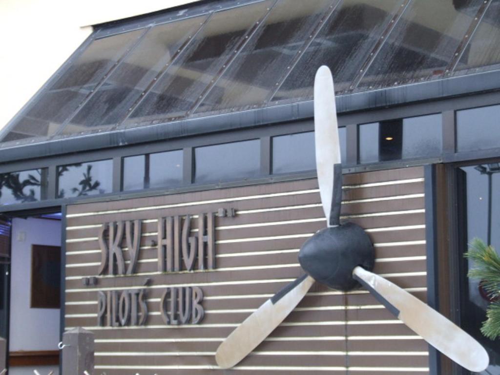 a large propeller on the side of a building at Sky High Hotel Airport 200 meters from the terminal in Riga