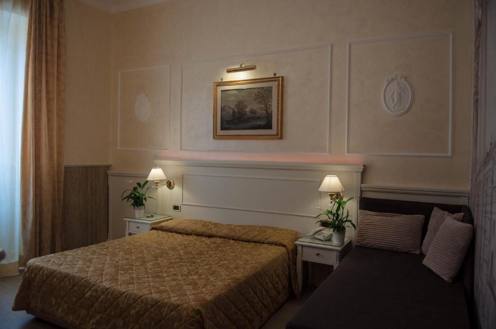 Postel nebo postele na pokoji v ubytování Hotel Palladium Palace