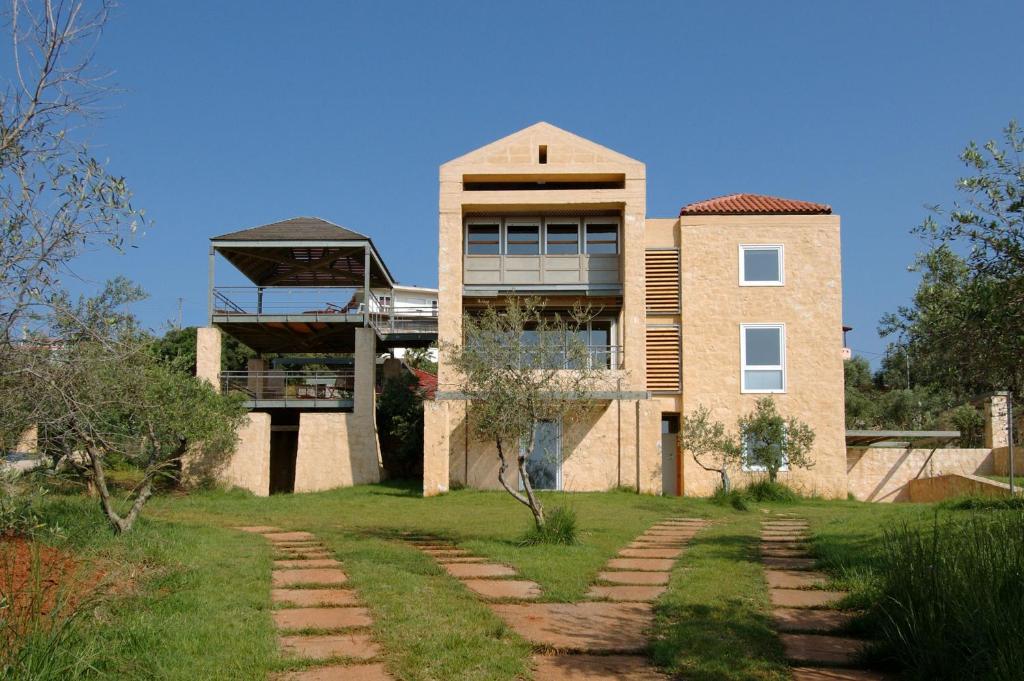 a large brick building with a walkway in front of it at Villa Catani in Kalamaki Chanion