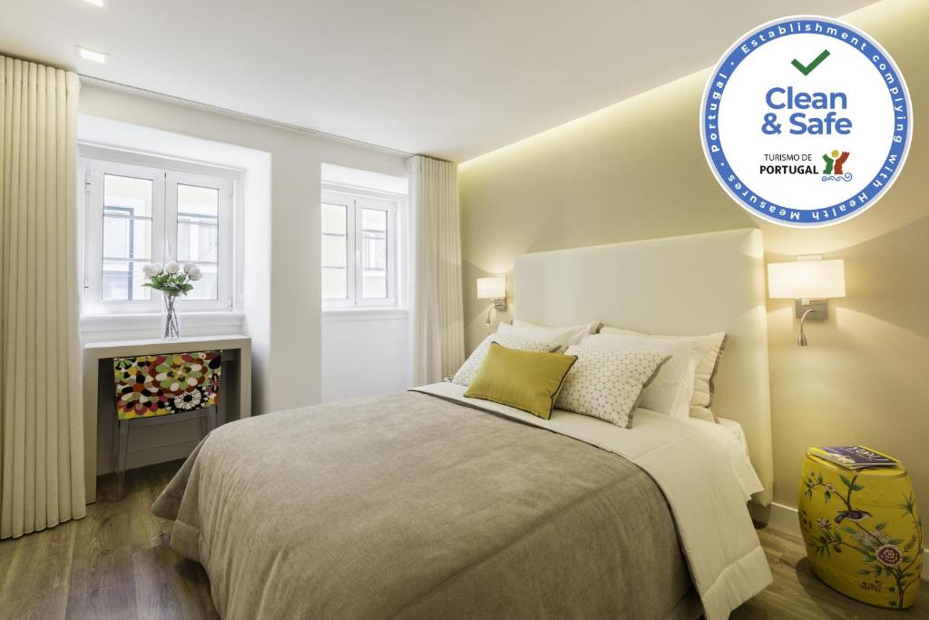 a bedroom with a bed and a sign that says clean and safe at Casa da Gloria in Lisbon