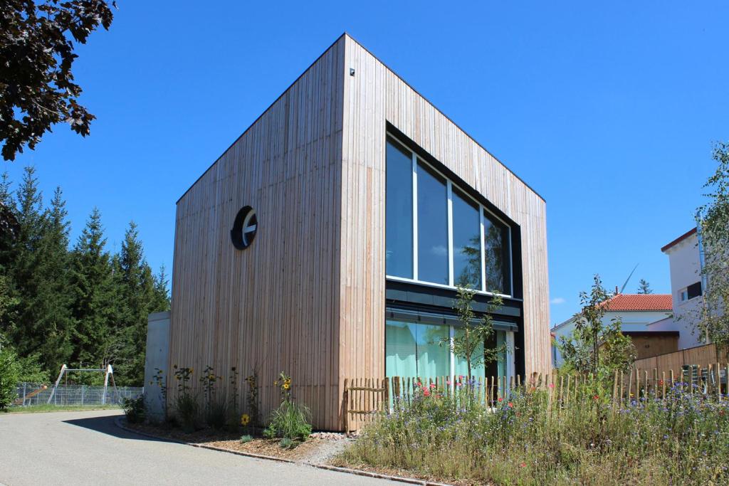 a brick building with a sign on the side of it at Apartment Monolith Black Forest in Schonach