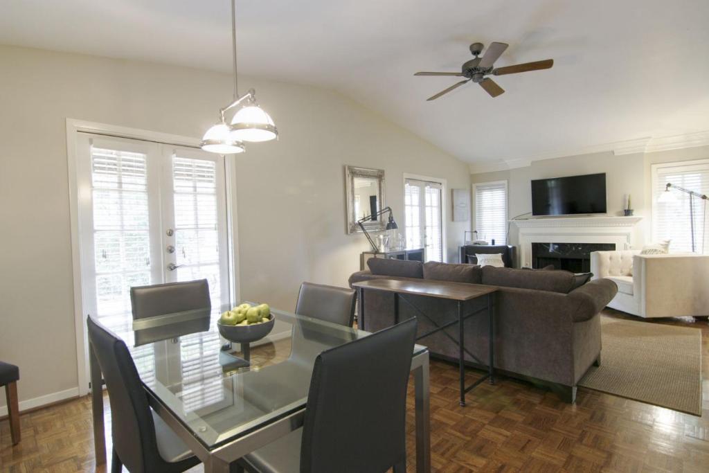 a living room with a couch and a table with chairs at Tarrytown Townhouse in Austin