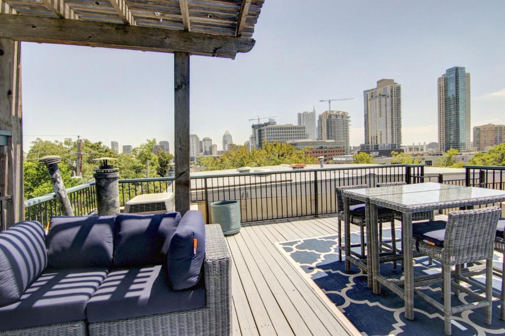 a patio with a couch and a table on a deck at Encinal Condominiums in Austin