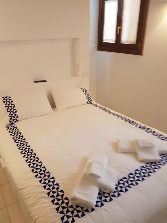 a bedroom with two beds with towels on them at Venice Venezia ,GHETTO,BIENNALE, Campo Maddalena in Venice