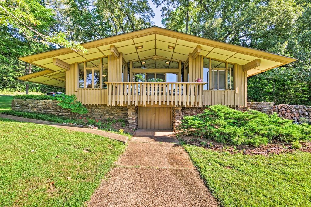 a large wooden house with a porch on a lawn at Tranquil Mid-Century Modern Cottage with Forest View in Hardy