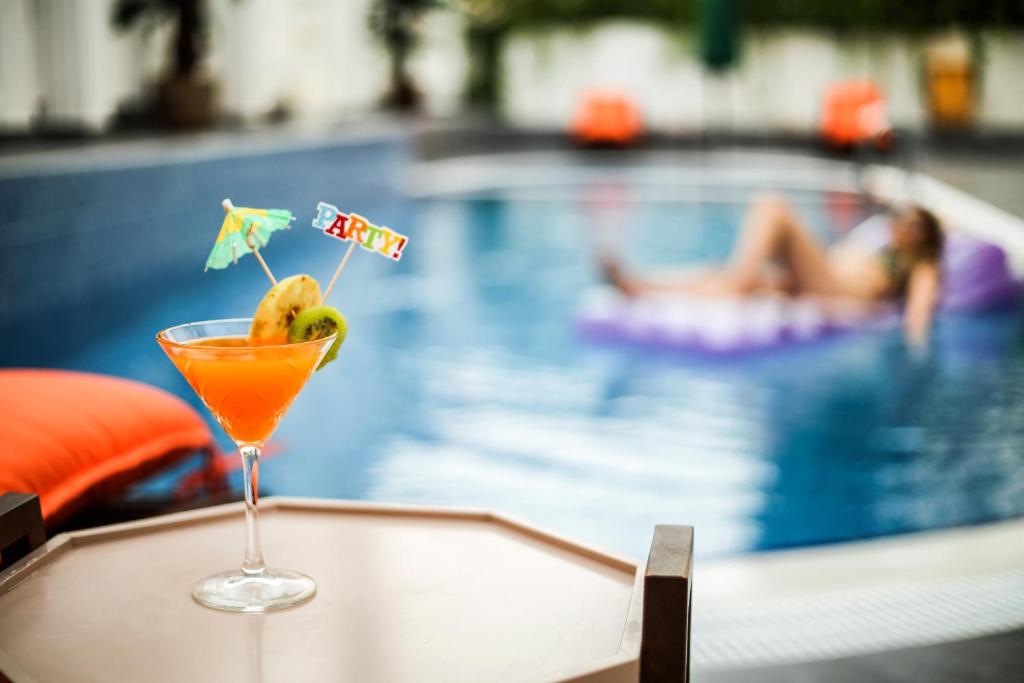 a drink sitting on a table next to a swimming pool at Anka Butik Hotel - Adults Only in Side