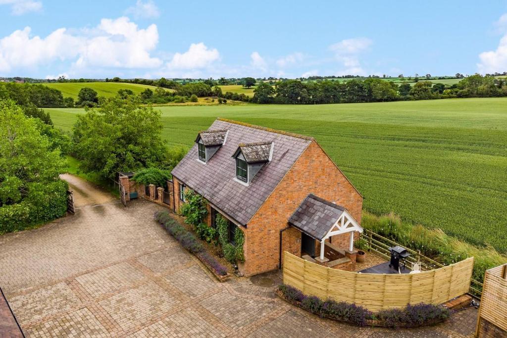 an overhead view of a house in the middle of a field at The Cottage - Luxury Romantic Retreat in Idyllic Rural Location in Clipston