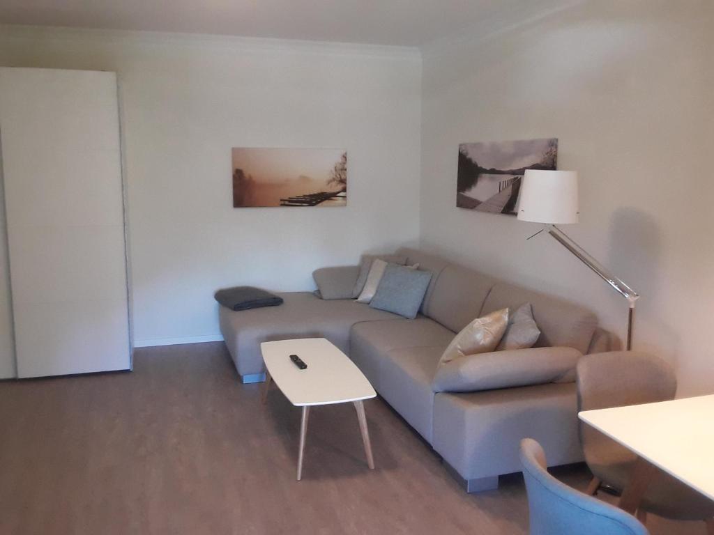 a living room with a couch and a table at Ferienwohnung 4 Familie Ramm in Eutin