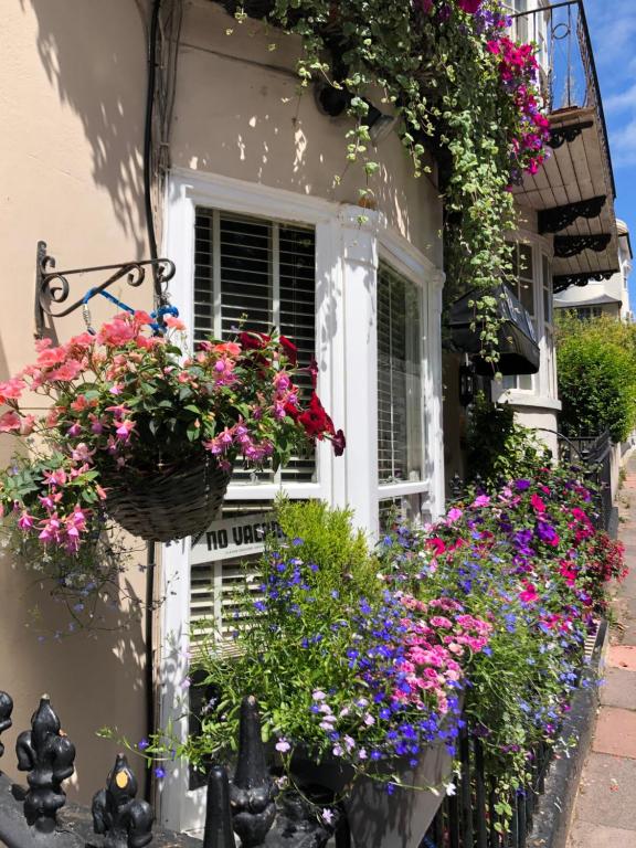 a window with flowers on the side of a house at Number14brighton in Brighton & Hove