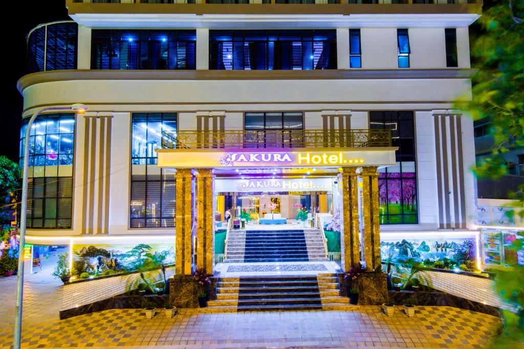 a large building with a staircase in front of it at SAKURA HOTEL in Hòa Bình