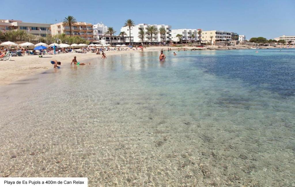 a group of people in the water at a beach at Casa Can Relax in Es Pujols