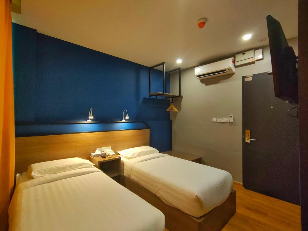 Postel nebo postele na pokoji v ubytování Uptown Hotel