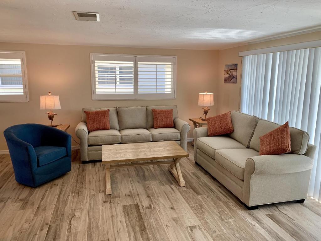 a living room with two couches and a coffee table at Island House Beach Resort 7 in Siesta Key
