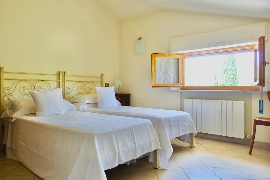 Postel nebo postele na pokoji v ubytování Casa GINESTRA a Bagno Vignoni