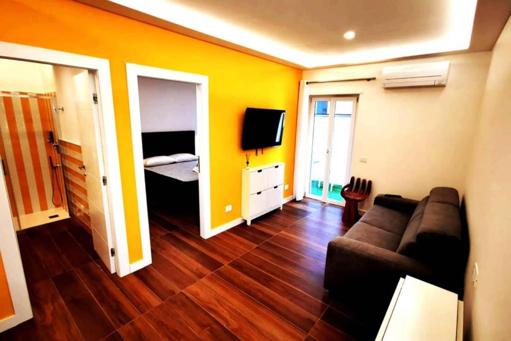 een woonkamer met een bank en een slaapkamer bij Sorrento Punto It Apartment in Sorrento