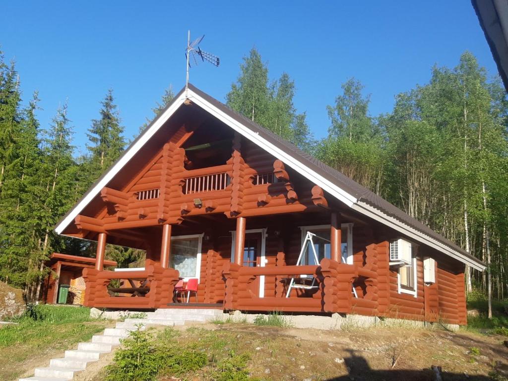 eine Blockhütte im Wald in der Unterkunft Saimaa Raikala in Vuoriniemi