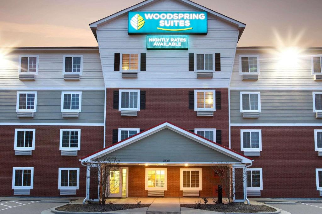 a building with a sign that reads woodworking suite at WoodSpring Suites Raleigh Northeast Wake Forest in Raleigh