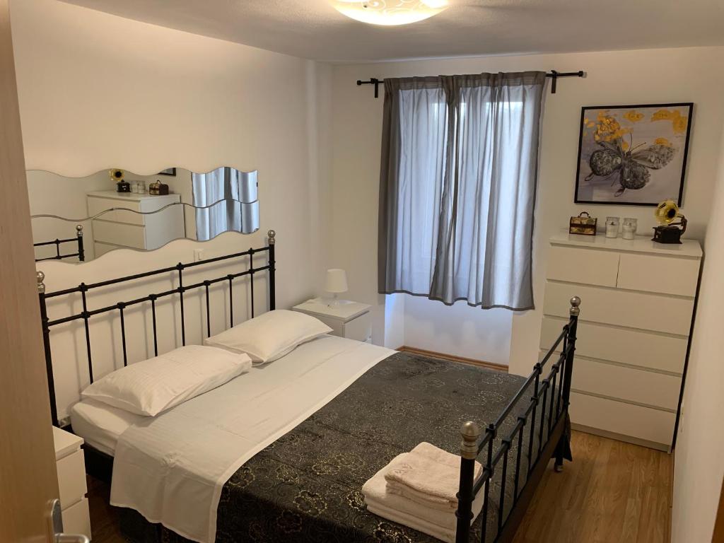 a bedroom with a large bed and a window at Apartment Matteotti 199 in Rovinj