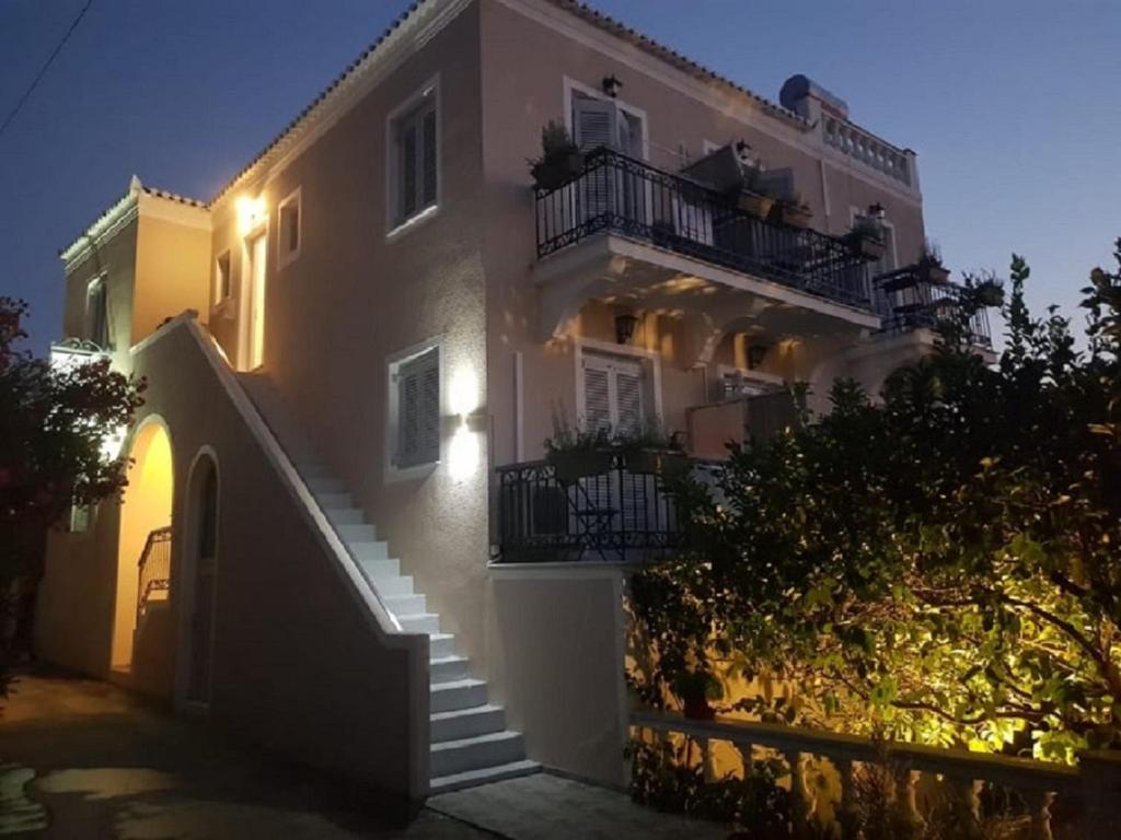 a large white building with stairs in front of it at Argonaftis Spetses in Spetses