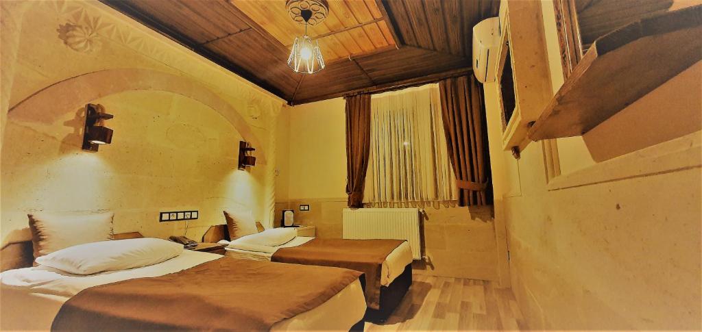 Postel nebo postele na pokoji v ubytování Ciner Hotel