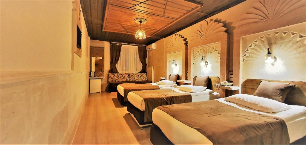 Postel nebo postele na pokoji v ubytování Ciner Hotel