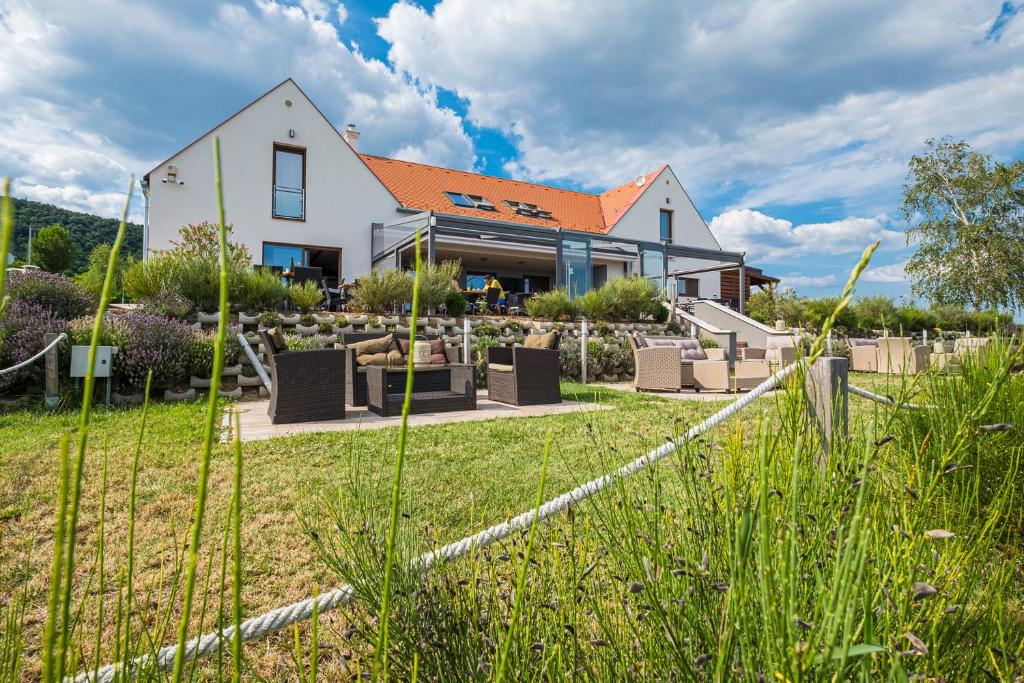 a house with a garden in front of it at Vitis Kúria 7171 Balatonrendes in Balatonrendes
