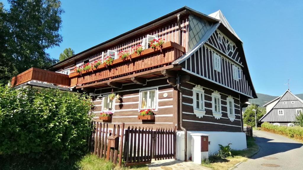 a house with flower boxes on the balcony at Chalupa pod Lysou in Rokytnice nad Jizerou