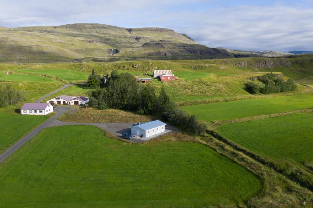 an aerial view of a house in a green field at Selfell Guesthouse by Stay Iceland in Kálfafell