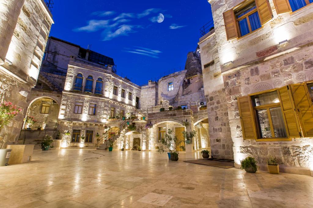a courtyard of an old building at night at Imperial Cave Suites & Spa in Göreme