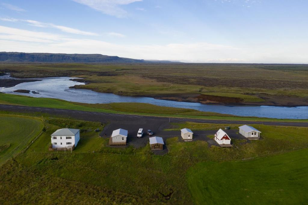 an aerial view of a group of houses next to a river at The Holiday Houses in Kirkjubæjarklaustur