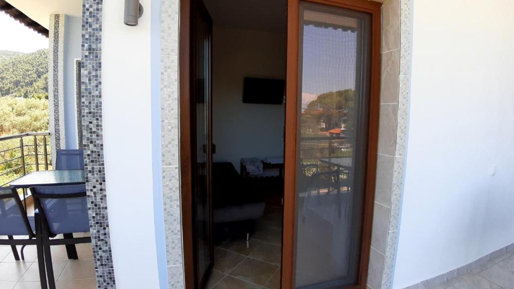 a sliding glass door with a view of a balcony at House Anna Houhlia in Vourvourou