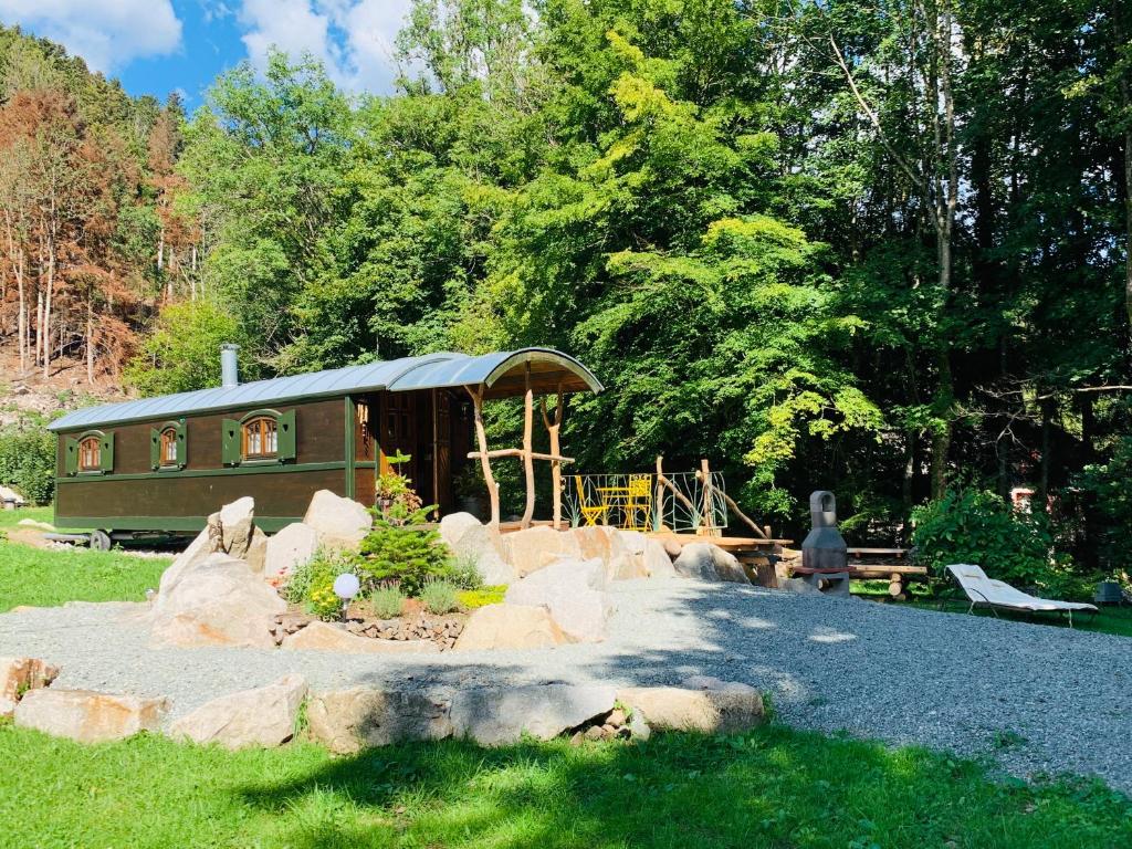 um pequeno parque num parque com uma cabana em La Roulotte du Randonneur em Rimbach-près-Masevaux