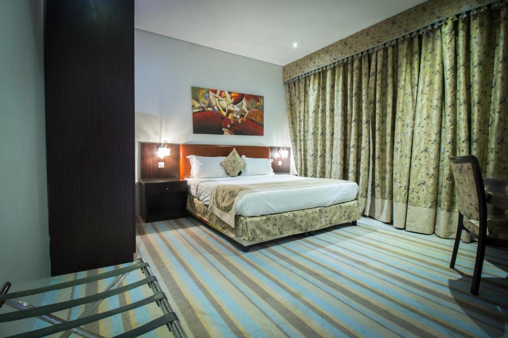 A bed or beds in a room at Amar Furnished Hotel Apartments