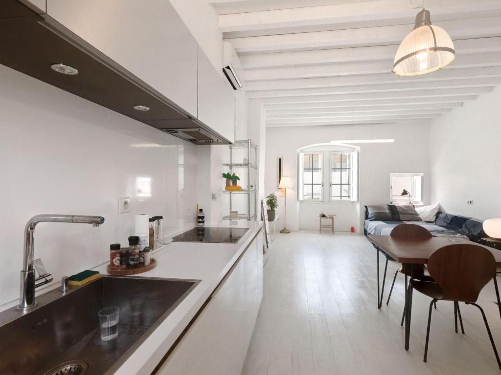 a kitchen with a sink and a table with chairs at Holiday Home in Avignon next to the City Centre in Avignon